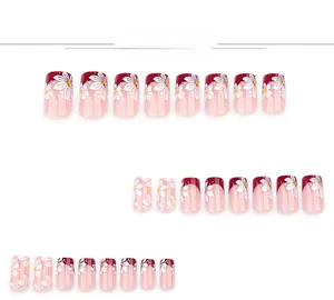 Close-up of 24pcs wine red and nude press-on nails with white daisy floral patterns