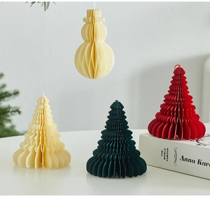 Close-up of honeycomb paper Christmas trees and snowman ornaments for holiday decor