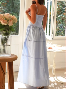 Detail of light blue spaghetti strap maxi dress with pleated elastic waist and tiered skirt