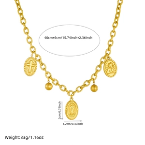 Gold vintage stainless steel necklace with oval coins and religious pendants on white background