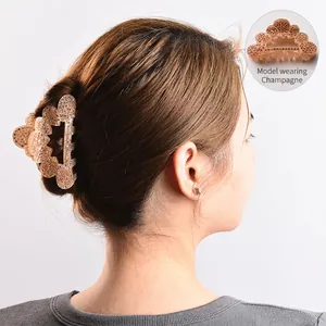 Champagne hair claw clip with rhinestones shown on model for elegant hairstyling