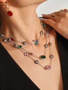 Detail of layered stainless steel necklace with colorful glass stones and matching jewelry set