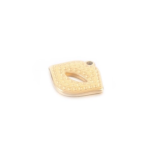 Fashionable gold lip shaped metal pendant with dotted texture and hanging loop accessory