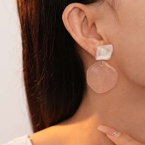 Sparkling pink resin geometric drop earrings with silver pins for women on model
