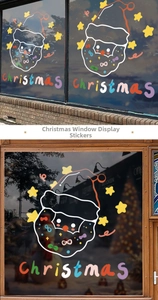 Detail of colorful Santa Claus static window stickers with Christmas lettering and stars