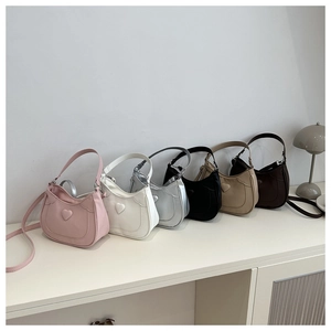 Chic saddle bags in various colors featuring embossed heart detail and crossbody straps