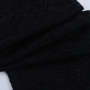 Detail of intricate black lace fabric showing delicate patterns and semi-sheer texture