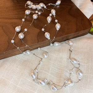 Elegant multi-layered long pearl necklace with irregular baroque pearls and silver metal chain