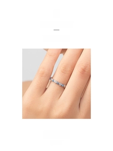 Macro view of S925 silver ring featuring alternating blue evil eye and hollow heart patterns