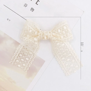 Elegant off-white hollow lace bow accessory for hair clips or DIY craft supplies