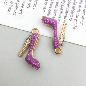 Detail of gold-plated high heel charms with purple enamel and sparkling crystals
