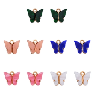 Close-up of 10 colorful acrylic butterfly charms in five shades with gold alloy loops