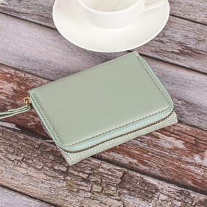 Detail view of mint green PU leather wallet with side metal zipper and folding structure