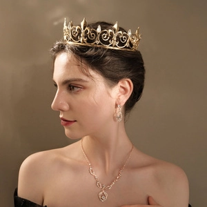 Close-up of baroque pearl crown and crystal jewelry set on model in gold finish