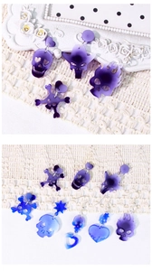 Detailed view of Halloween skull, bat, and star acrylic earrings in purple and blue