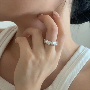 Minimalist S925 sterling silver ring with geometric triangle design worn on a model's finger