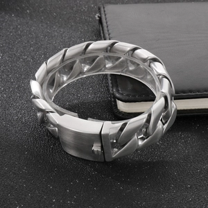 Close-up of industrial silver titanium steel Cuban link bracelet with matte brushed finish