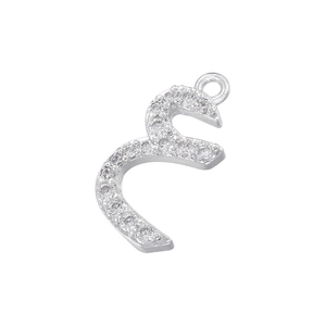 Macro view of silver Arabic letter pendant with shiny cubic zirconia stones and ring loop