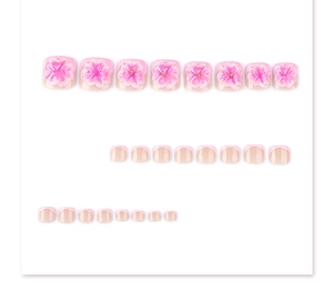 Detail of 3D pink floral press-on toe nails with French tips and golden bead accents