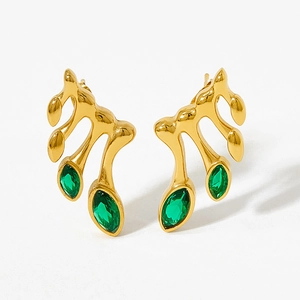 Detail of leaf-shaped gold stud earrings with marquise-cut green zircon stones