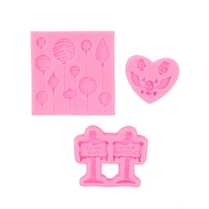 Pink silicone molds with Christmas road signs, balloons, and skull motifs for DIY crafts
