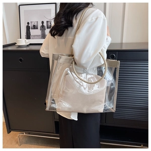 Close-up of transparent PVC tote bag with sturdy woven rope handles and inner pouch