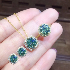 Golden jewelry set with 4 pieces featuring round green moissanite and halo diamond design