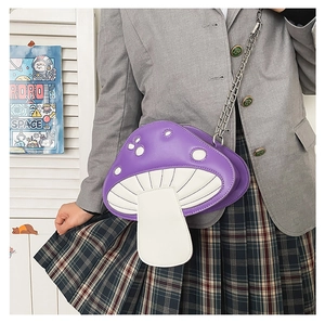 Fashionable purple mushroom cross-body bag with chain strap styled on a model's shoulder
