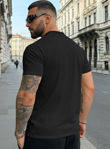 Back view of men's plain black cotton Henley t-shirt featuring casual urban street style