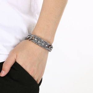 Close-up of vintage silver titanium steel bracelet with cross pattern on model's wrist
