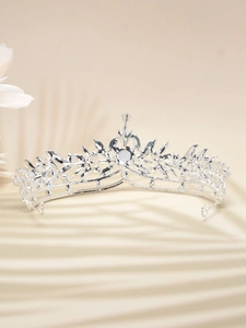 Close-up of silver bridal crown with white pearls and sparkling crystal vine details