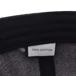 Detail view of cotton baseball cap interior with sweatband and 100% cotton wash label