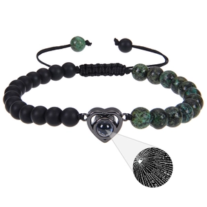 Macro detail of the 100 languages I Love You projection stone and natural turquoise beads