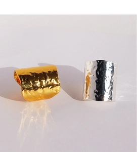 Macro shot of gold and silver wide lava texture rings with unique hammered finish surface