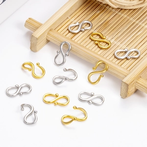 Golden and silver stainless steel S-shaped clasps for jewelry making on bamboo tray