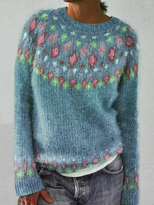 Detail of round neck knit sweater featuring colorful geometric jacquard pattern on collar