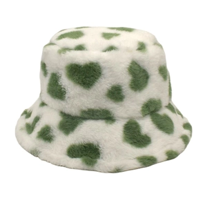 Detail of soft white faux fur bucket hat featuring vibrant green heart patterns