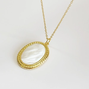 Elegant gold oval pendant necklace featuring natural iridescent mother of pearl shell