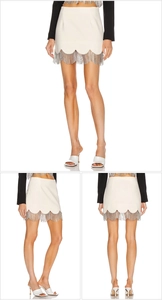 Detailed views of a white mini skirt featuring wavy hem and sparkling crystal tassels