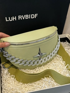 Detailed macro view of mint green crescent bag with star metal and chunky silver chain