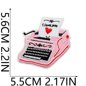 Detail of pink typewriter embroidery patch with 'I love you' text and red heart