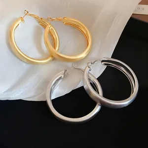 Minimalist matte gold and silver chunky hoop earrings set with brushed metal texture
