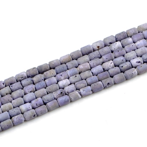 Close-up of barrel-shaped 6x8mm natural druzy agate beads with raw crystal texture