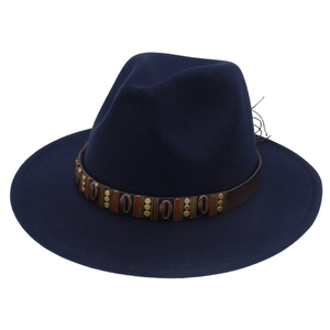 Detail of the navy blue wool fedora featuring a leather band with metal shell ornaments