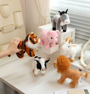 Detailed close-up of a plush animal set including a tiger, lion, and pig on a desk