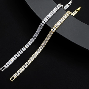 Elegant gold and silver tennis bracelets with rectangular cubic zirconia on a black stand