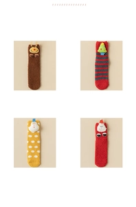 Detail of four festive coral fleece Christmas socks featuring reindeer and Santa dolls