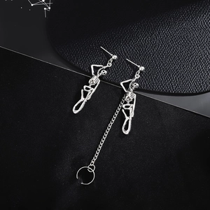 Vintage punk silver skull earrings with asymmetric long chains and cuff rings on black leather
