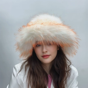 Detailed close-up of fluffy white faux fur winter hat with orange tips on a model