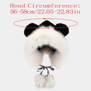Detailed view of plush panda hat featuring fluffy pom-poms and soft faux fur texture